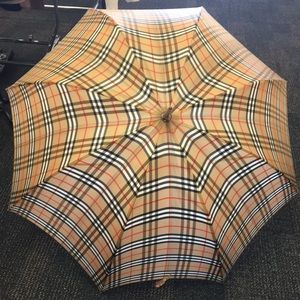Burberry umbrella with wooden handle grip.